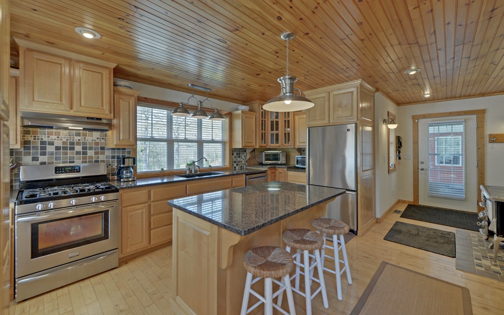 202 Dove Lane Morganton, GA 30560 - Photo 26 of 99 a kitchen with stainless steel appliances granite countertop a stove a sink and a refrigerator