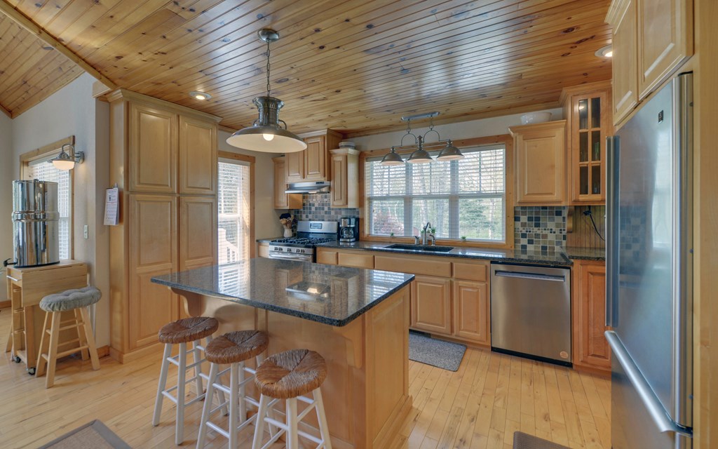 202 Dove Lane Morganton, GA 30560 - Photo 27 of 99 a kitchen with stainless steel appliances granite countertop a sink a stove and a refrigerator