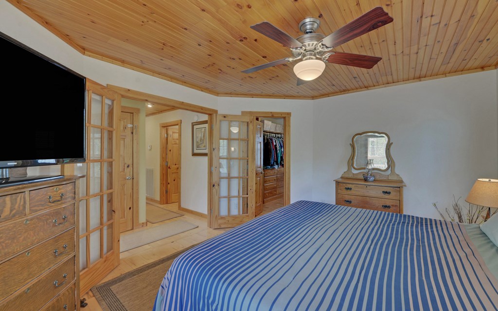 202 Dove Lane Morganton, GA 30560 - Photo 32 of 99 a bedroom with a bed and a flat tv screen on dresser