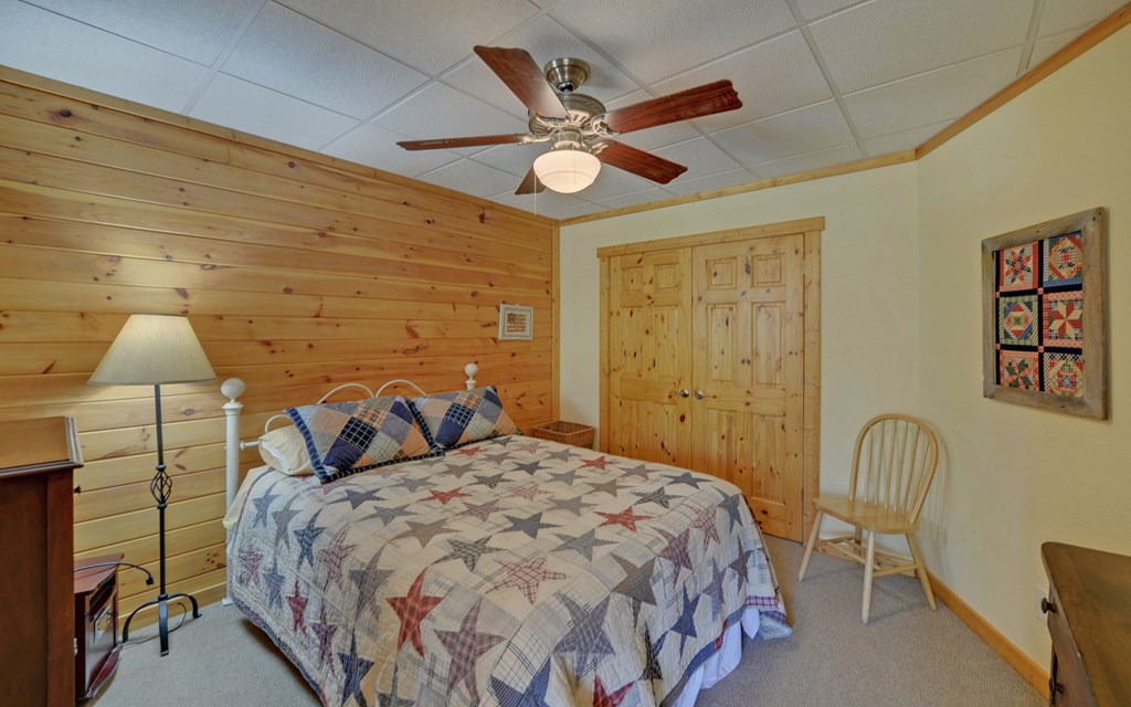 202 Dove Lane Morganton, GA 30560 - Photo 43 of 99 a bedroom with a bed and a chandelier