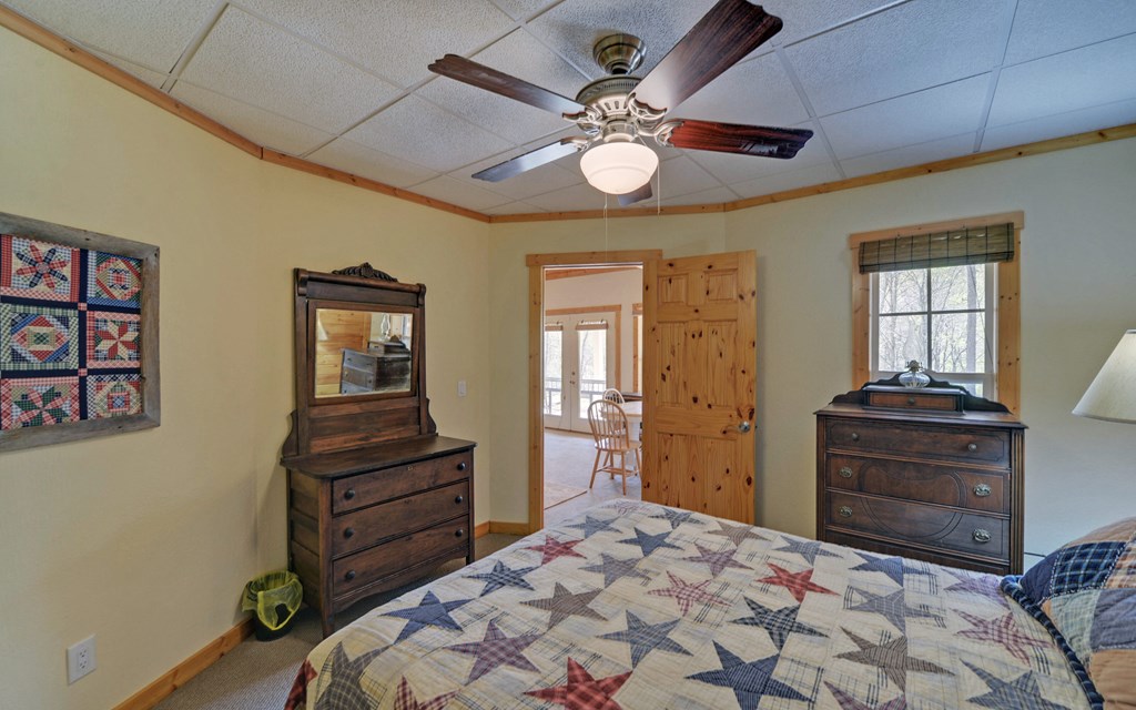 202 Dove Lane Morganton, GA 30560 - Photo 44 of 99 a bedroom with a bed and a chandelier