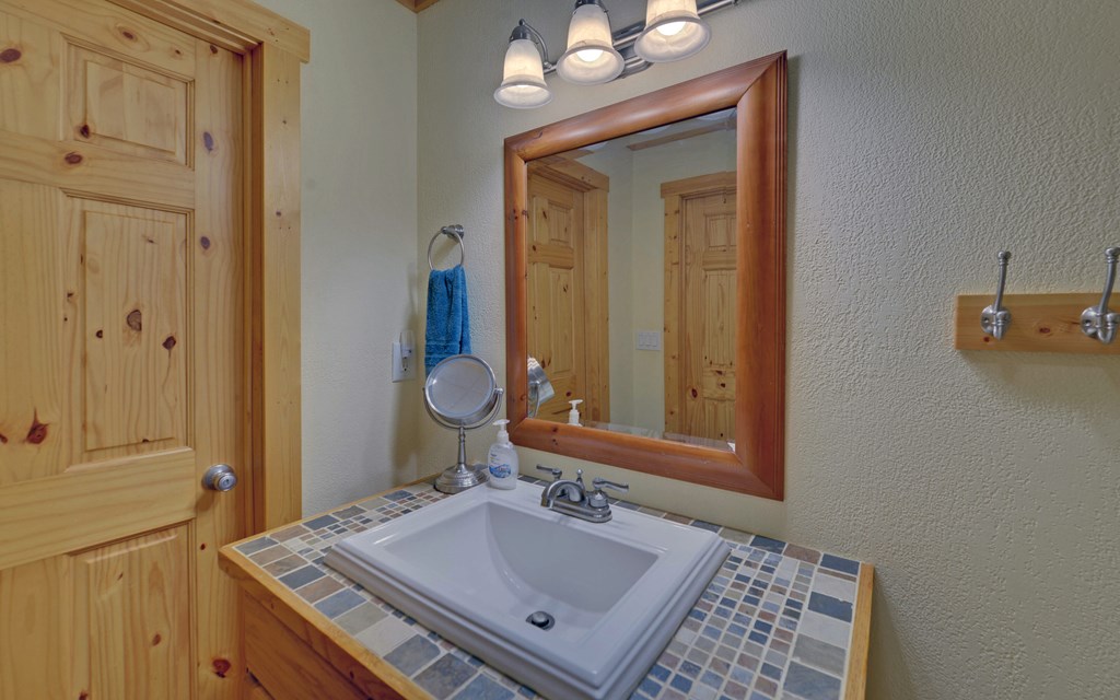 202 Dove Lane Morganton, GA 30560 - Photo 45 of 99 a bathroom with a sink vanity granite and a mirror