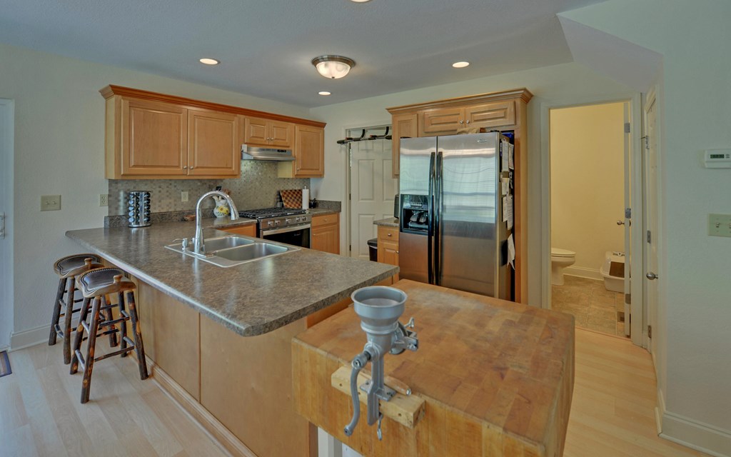 202 Dove Lane Morganton, GA 30560 - Photo 6 of 99 a kitchen with stainless steel appliances granite countertop a sink a stove and a refrigerator