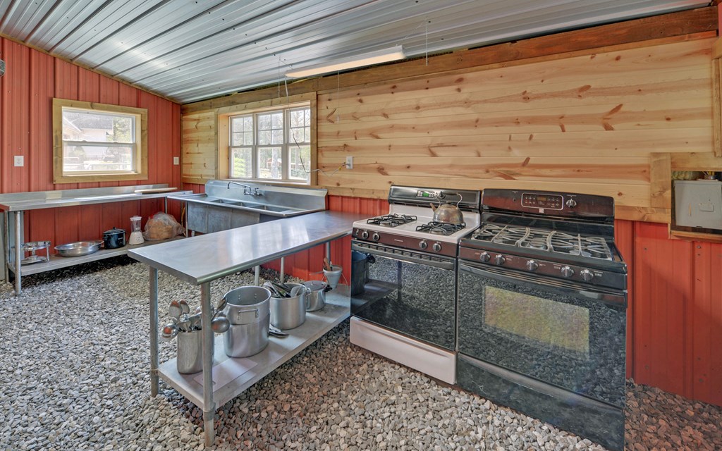 202 Dove Lane Morganton, GA 30560 - Photo 62 of 99 a kitchen with stainless steel appliances granite countertop a stove and a sink