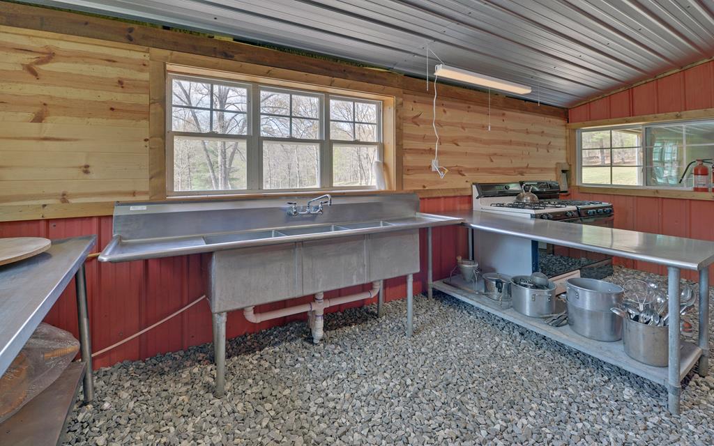 202 Dove Lane Morganton, GA 30560 - Photo 64 of 99 a kitchen with stainless steel appliances granite countertop a sink and a stove