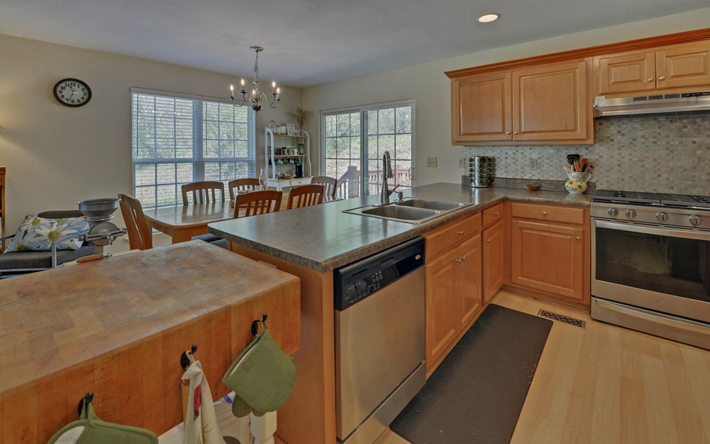 202 Dove Lane Morganton, GA 30560 - Photo 10 of 99 a kitchen with stainless steel appliances granite countertop a stove a sink dishwasher and a microwave oven with white cabinets
