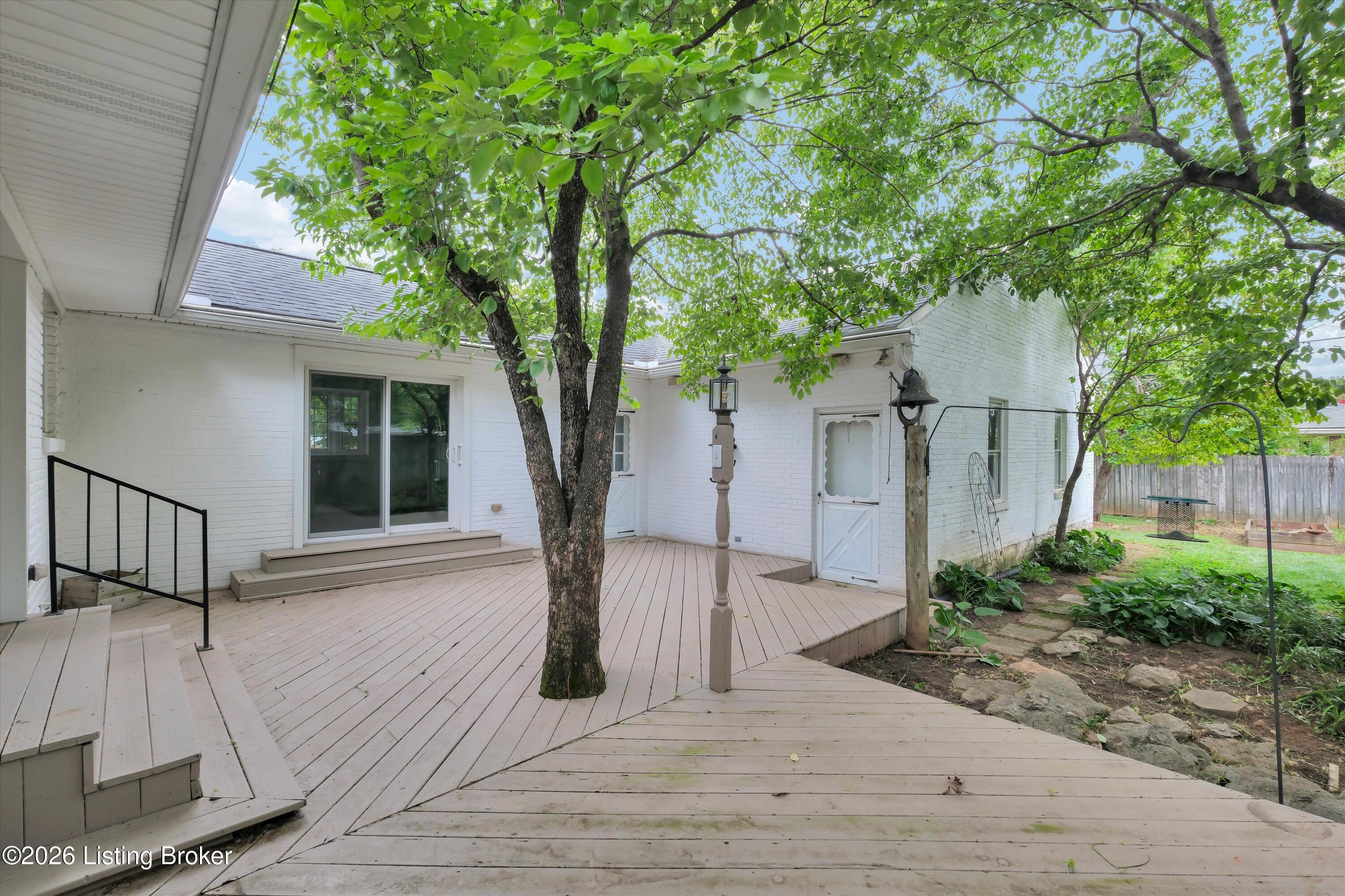 6901 Greenlawn Road Louisville, KY 40222 - Photo 36 of 44 Lovely deck built around shady tree. Easily accessed from kitchen, study, and garage. Private setting with mature landscaping.