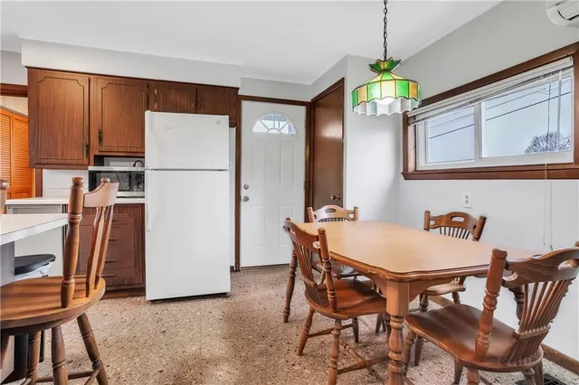 a view of a dining room with furniture and a chandelier