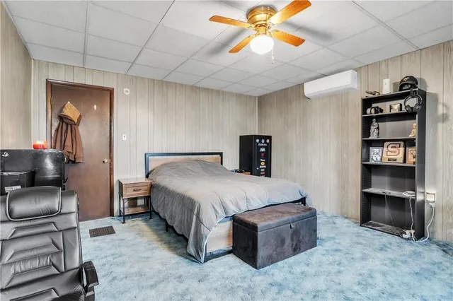 a spacious bedroom with a bed and a cabinets