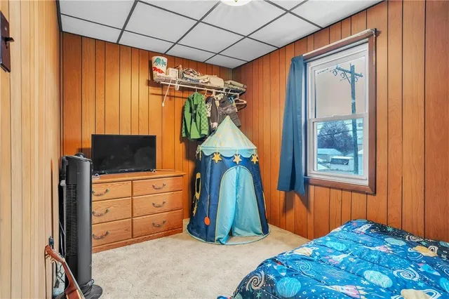 a bedroom with a bed and a flat tv screen