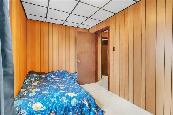 a bedroom with a bed and curtain