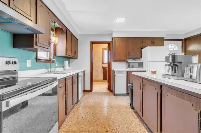 a kitchen with stainless steel appliances a sink stove and cabinets