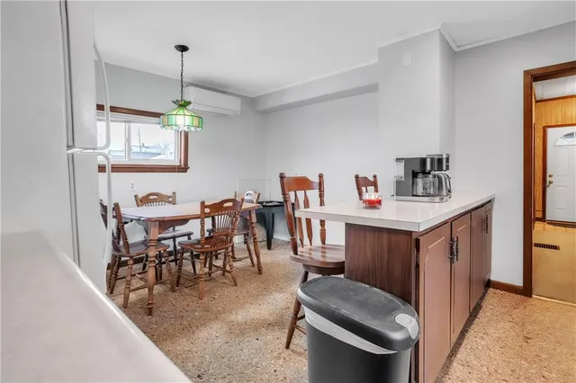 a dining room with furniture and a chandelier