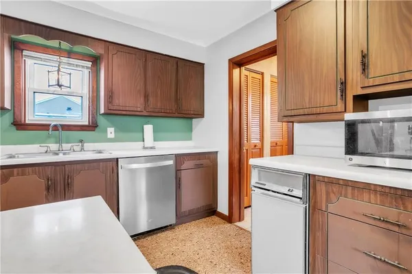 a kitchen with stainless steel appliances granite countertop a sink stove and cabinets