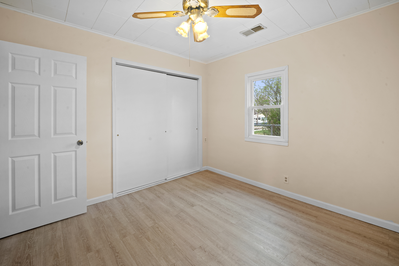 730 5th Street Buffalo, IA 52728 - Photo 12 of 16 wooden floor in an empty room with a window