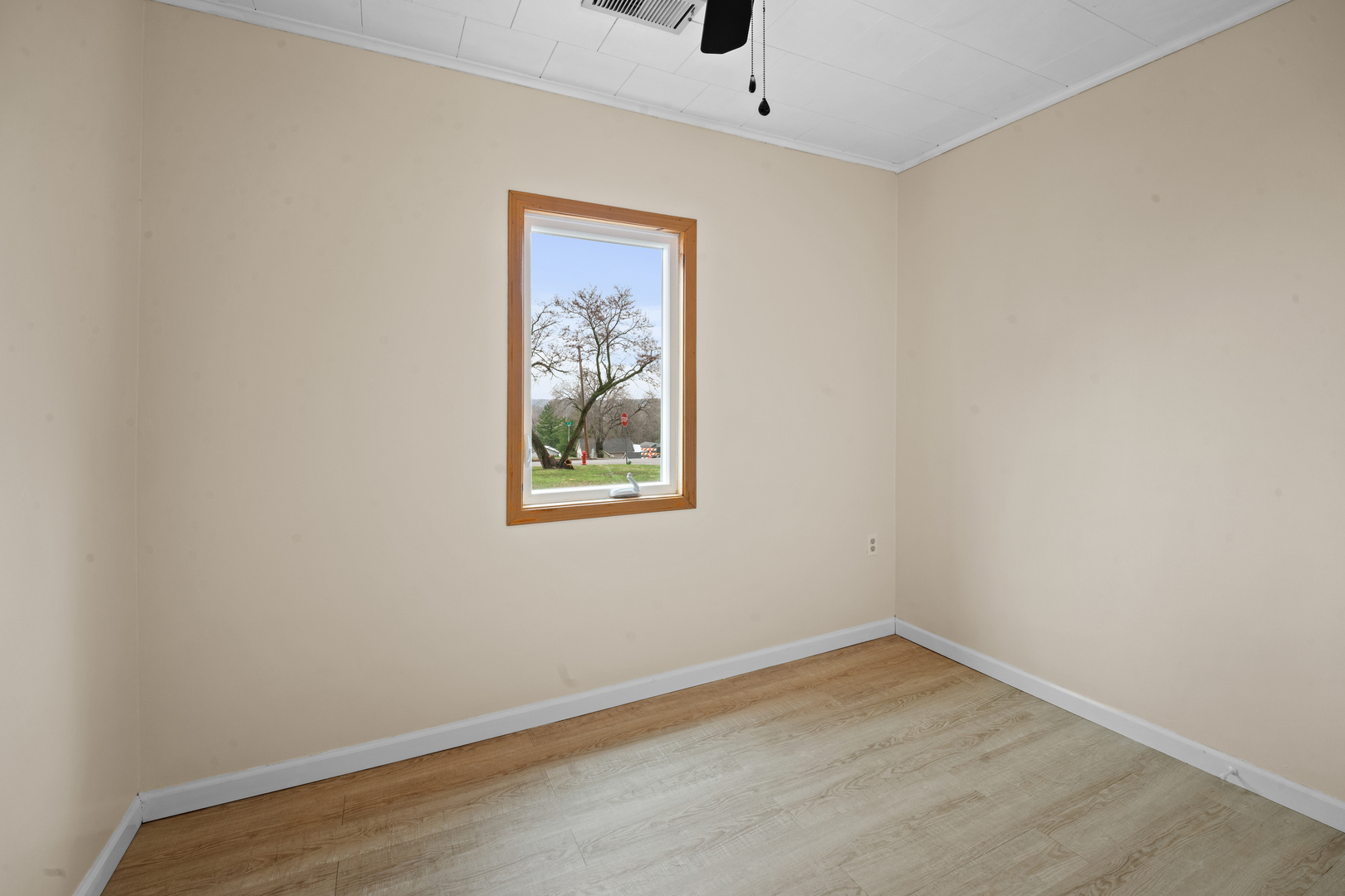 730 5th Street Buffalo, IA 52728 - Photo 13 of 16 an empty room with a window and a ceiling fan
