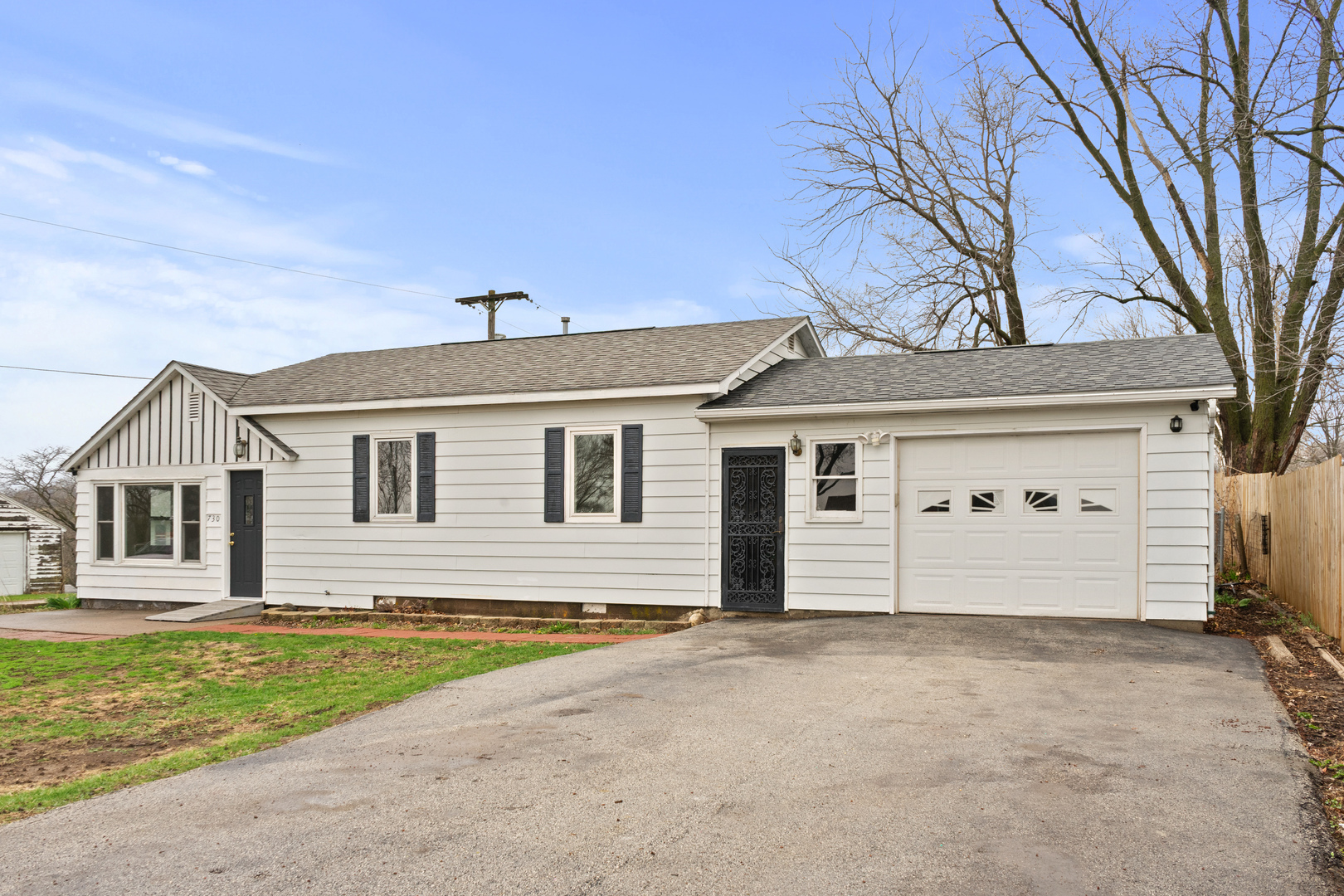 730 5th Street Buffalo, IA 52728 - Photo 16 of 16 a front view of a house with a yard and garage
