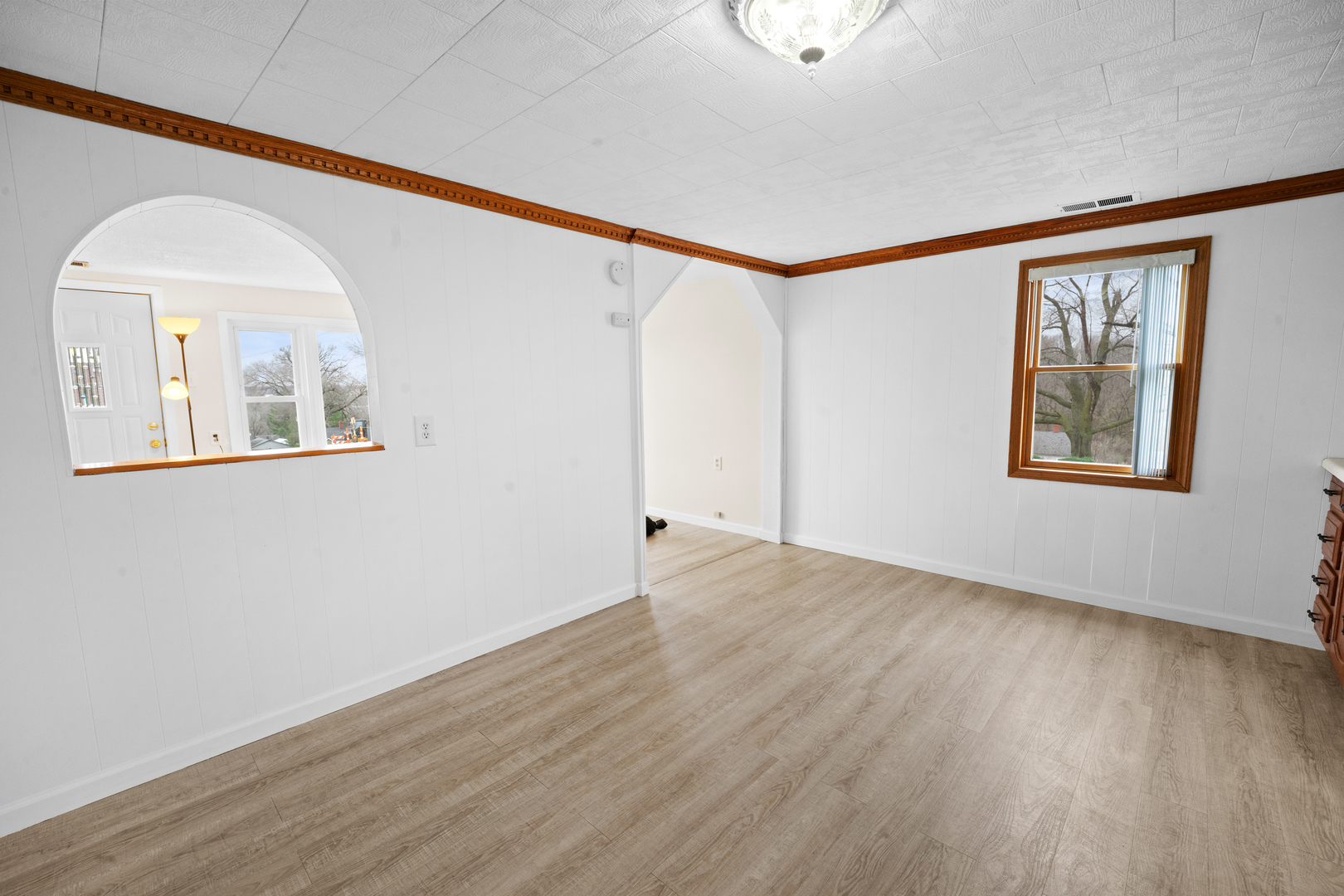 730 5th Street Buffalo, IA 52728 - Photo 7 of 16 a view of an empty room with wooden floor and a window
