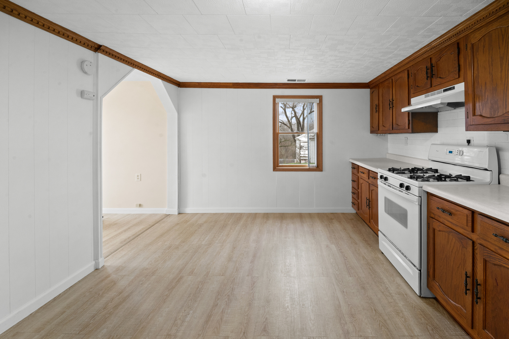 730 5th Street Buffalo, IA 52728 - Photo 8 of 16 a kitchen with stainless steel appliances granite countertop a stove a sink and a refrigerator with wooden floor