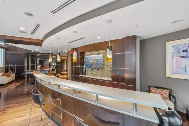 a living room with furniture a flat screen tv and a large window