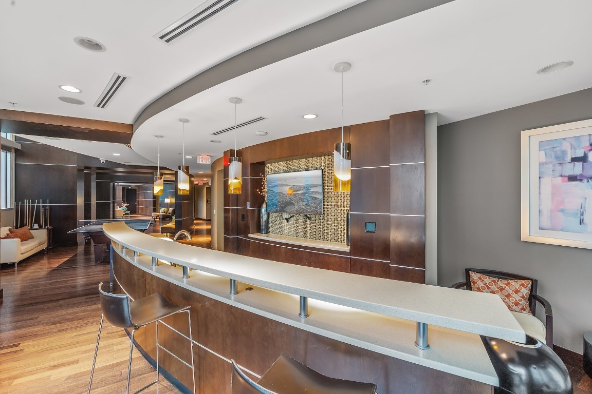 360 Nueces Street, Unit 911 Austin, TX 78701 - Photo 29 of 31 a room with wooden floor and furniture