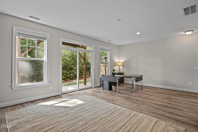 a kitchen view with wooden floor and electronic appliances