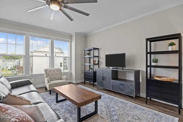 a view of a room with wooden floor windows and stairs