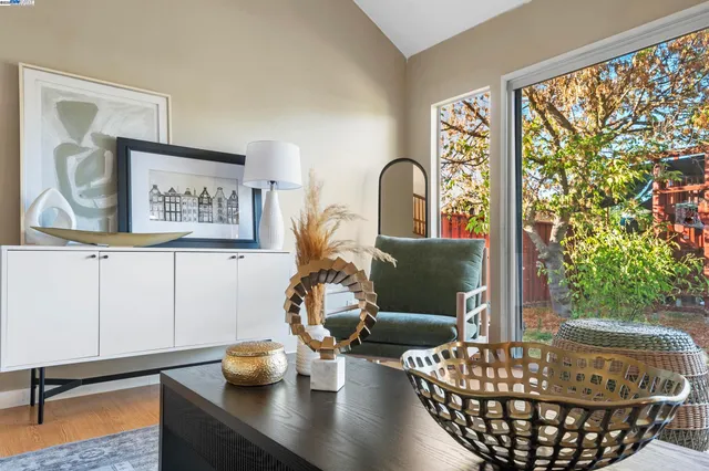 a living room with furniture and a potted plant