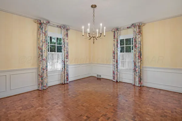 a view of a dining room with furniture and chandelier