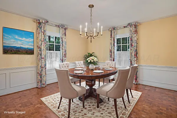 a view of a hallway with an empty room and chandelier fan