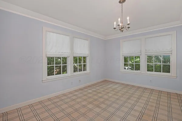 a view of house with a backyard