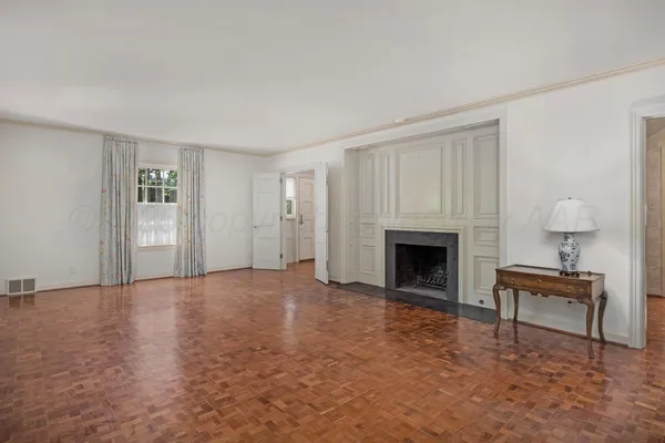 a living room with furniture a rug and a fireplace