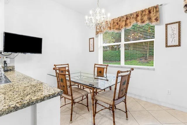 a living room with furniture a window and a chandelier