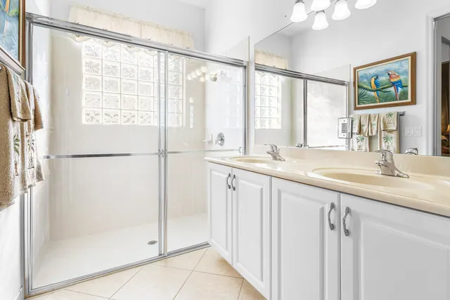 a bathroom with double sink and a mirror