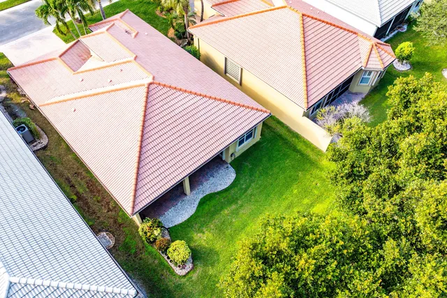 an aerial view of residential houses with outdoor space and swimming pool