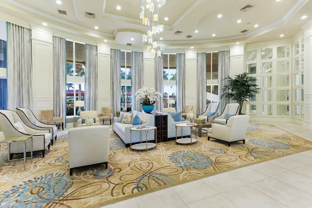 a row of palm trees and swimming pool in the backyard of a house