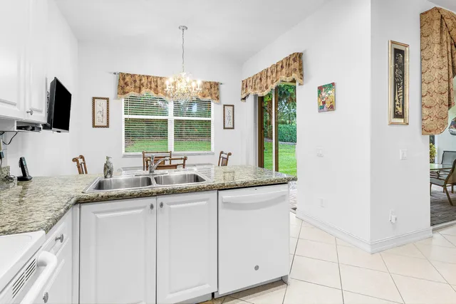 a kitchen with stainless steel appliances granite countertop a sink refrigerator and microwave