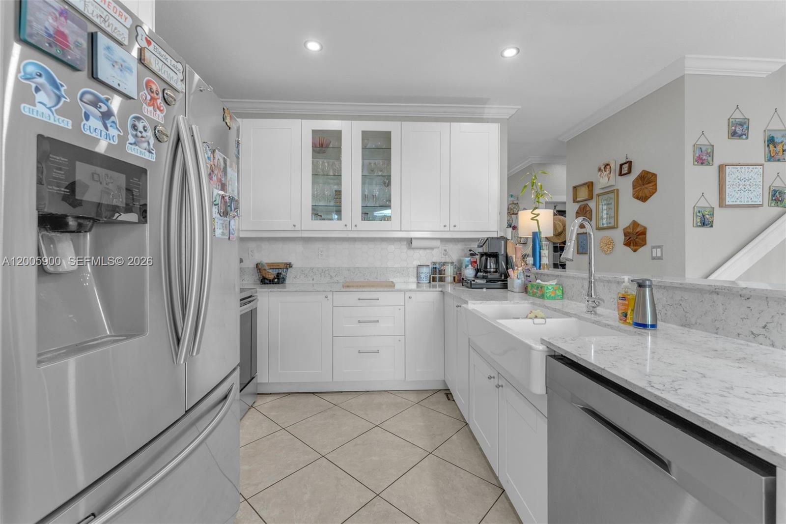 945 Southwest 154th Court Miami, FL 33194 - Photo 13 of 49 a kitchen with stainless steel appliances granite countertop a refrigerator and a sink