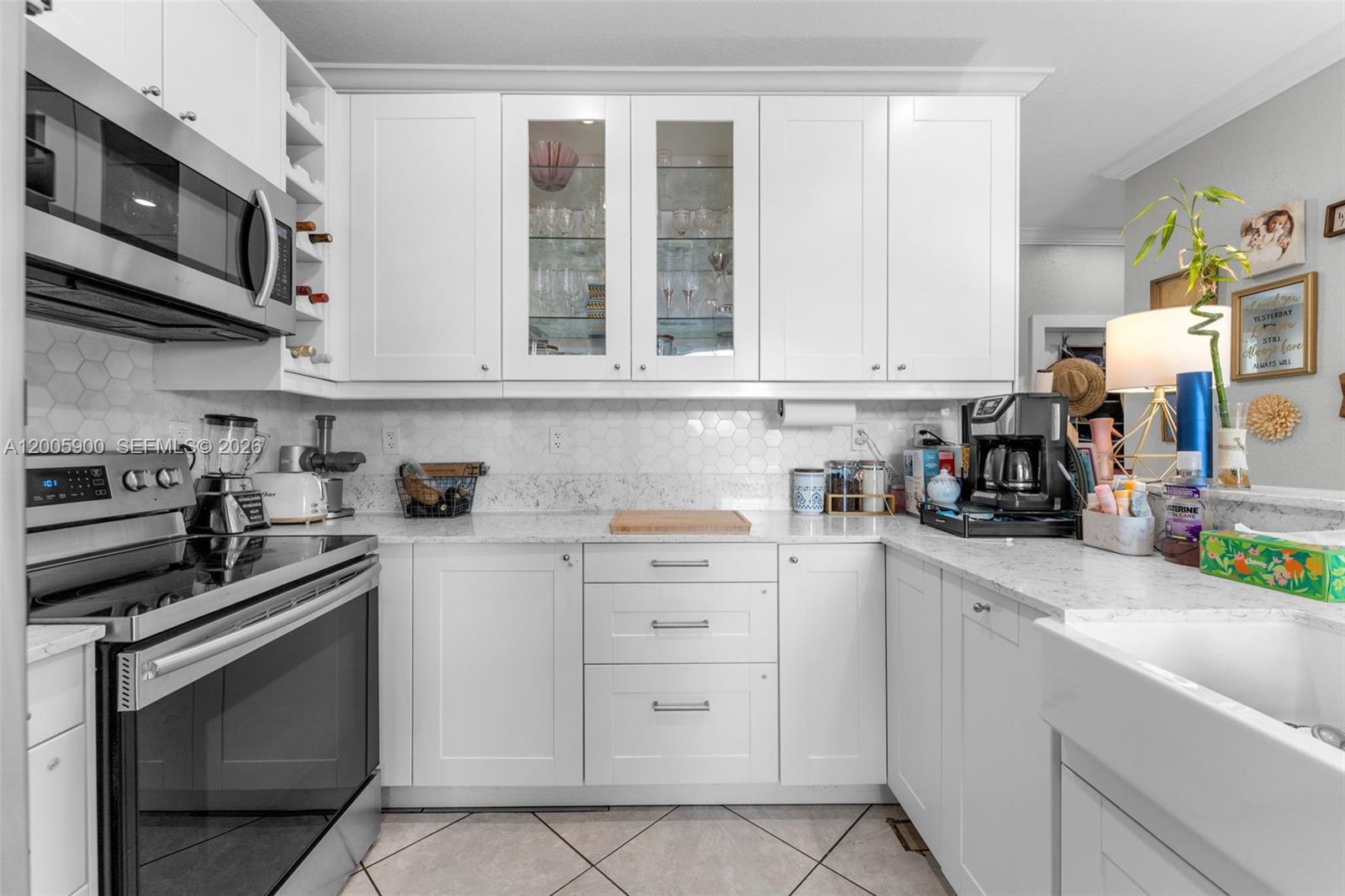 945 Southwest 154th Court Miami, FL 33194 - Photo 14 of 49 a kitchen with stainless steel appliances granite countertop white cabinets and a stove
