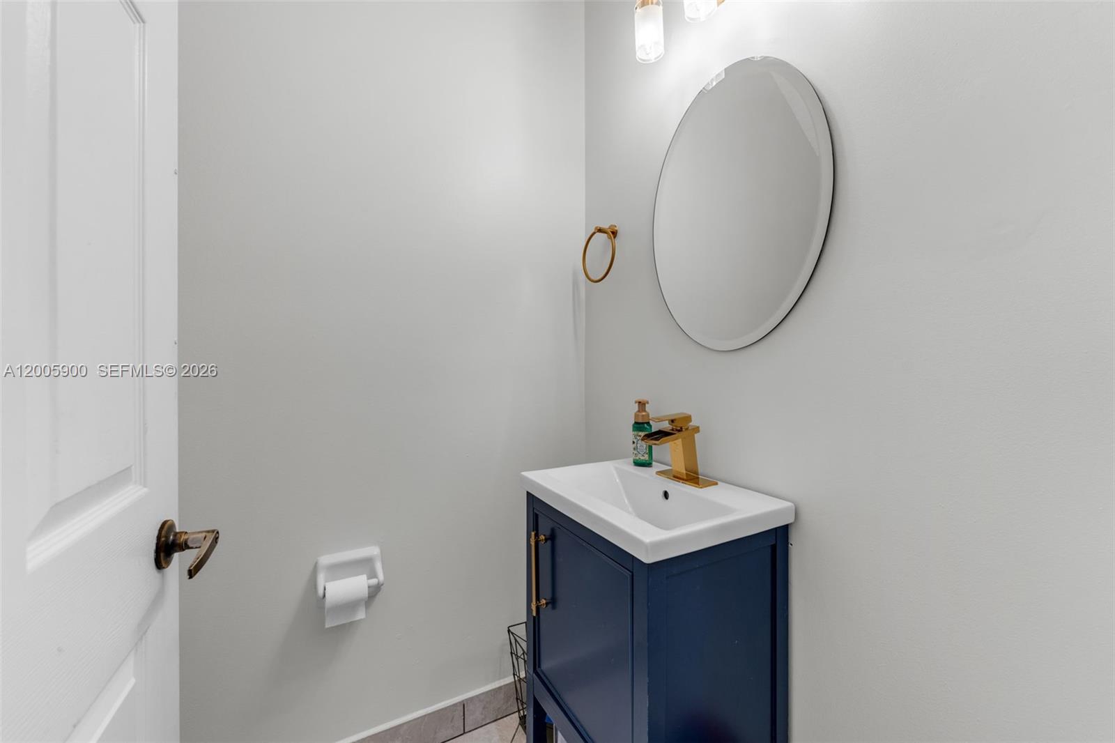945 Southwest 154th Court Miami, FL 33194 - Photo 16 of 49 a bathroom with a sink and a mirror