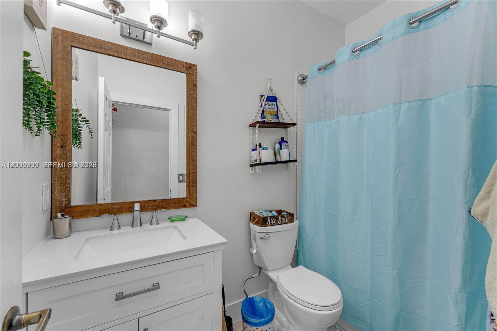 945 Southwest 154th Court Miami, FL 33194 - Photo 20 of 49 a bathroom with a sink a toilet and shower curtain