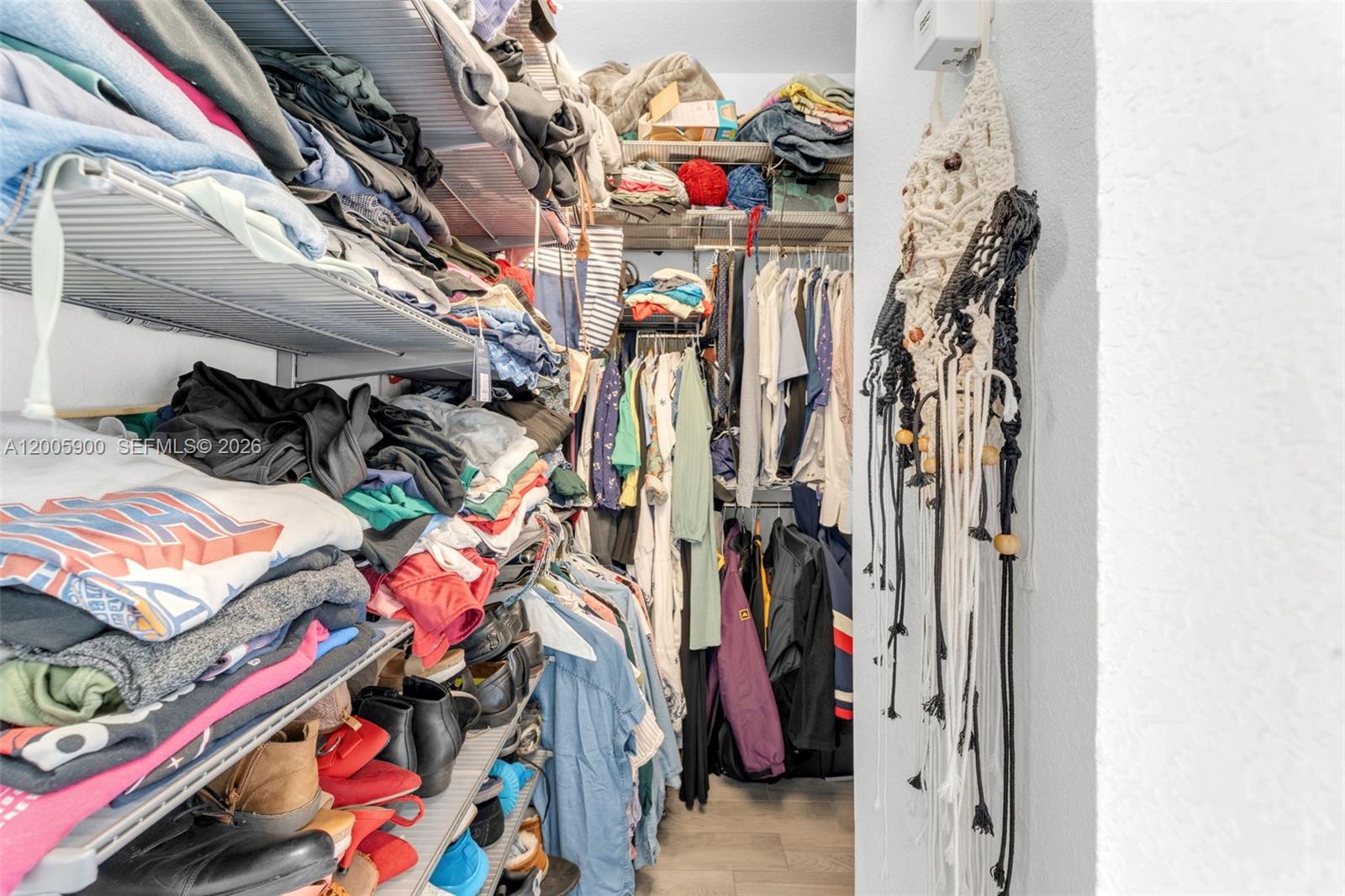 945 Southwest 154th Court Miami, FL 33194 - Photo 22 of 49 a view of walk in closet with clothes and shoes