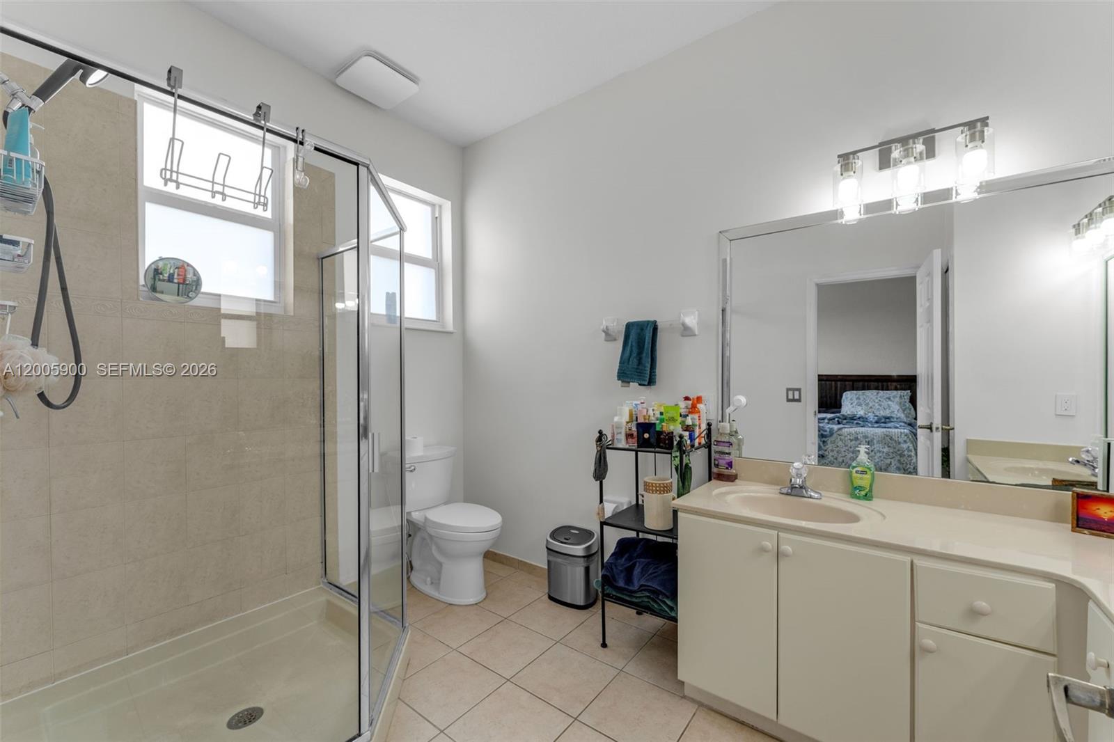 945 Southwest 154th Court Miami, FL 33194 - Photo 23 of 49 a bathroom with a double vanity sink toilet and shower