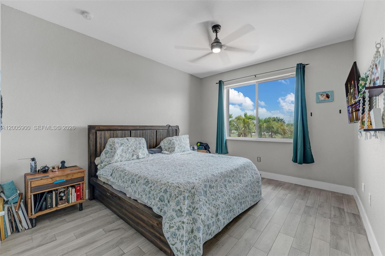 945 Southwest 154th Court Miami, FL 33194 - Photo 26 of 49 a bedroom with a large bed a flat tv screen and a dresser