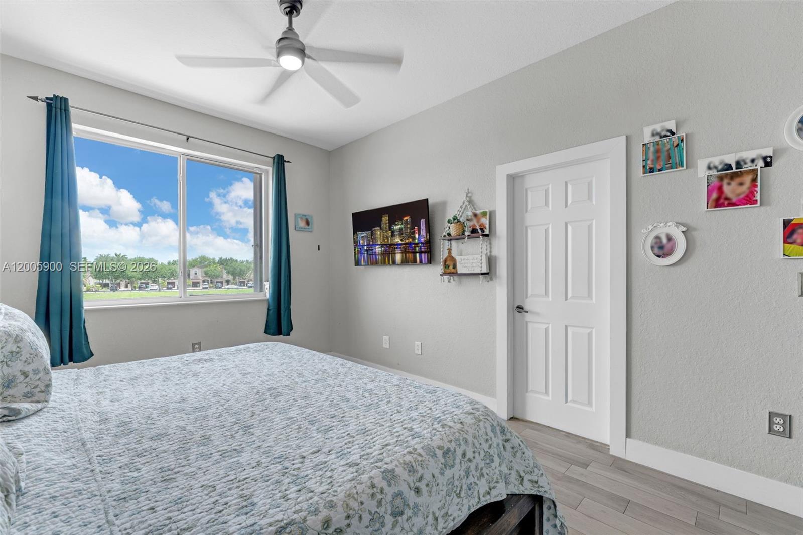 945 Southwest 154th Court Miami, FL 33194 - Photo 27 of 49 a bedroom with a large bed and a window