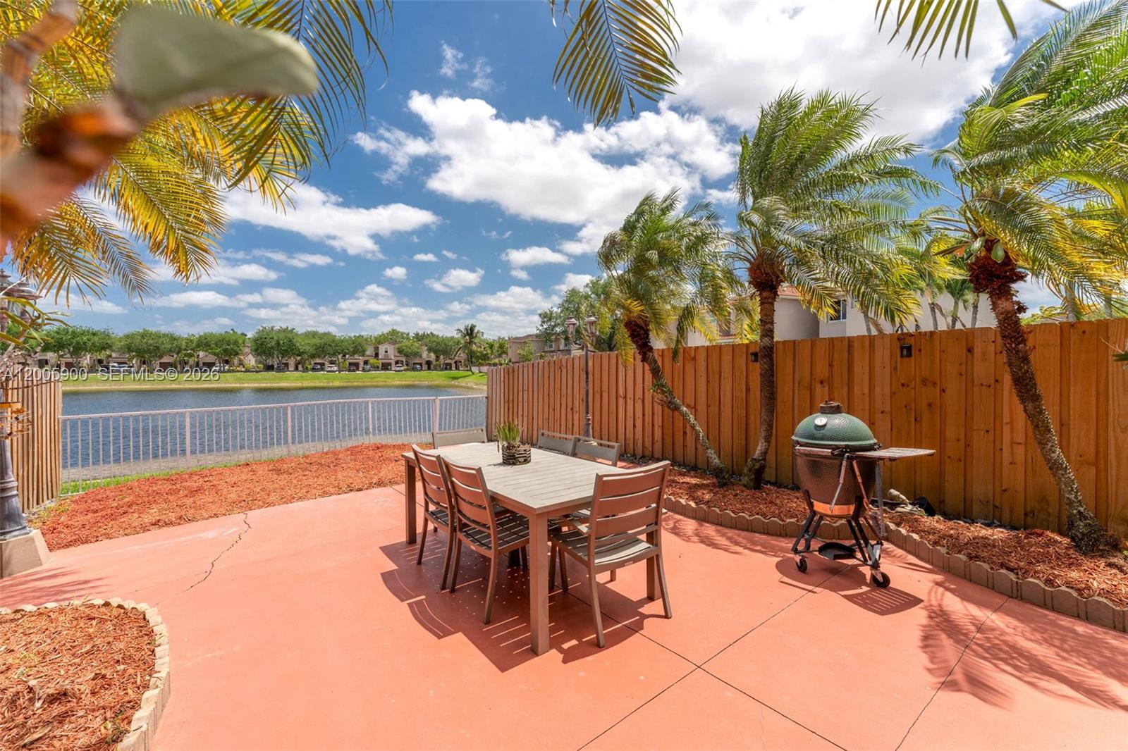 945 Southwest 154th Court Miami, FL 33194 - Photo 30 of 49 a roof deck with table and chairs under an umbrella