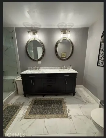 a bathroom with a double vanity sink and a mirror