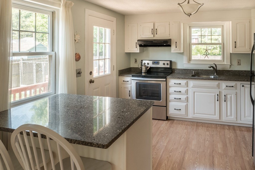 8 May Street Sharon, MA 02067 - Photo 3 of 8 a kitchen with stainless steel appliances granite countertop a stove a sink and a granite counter tops