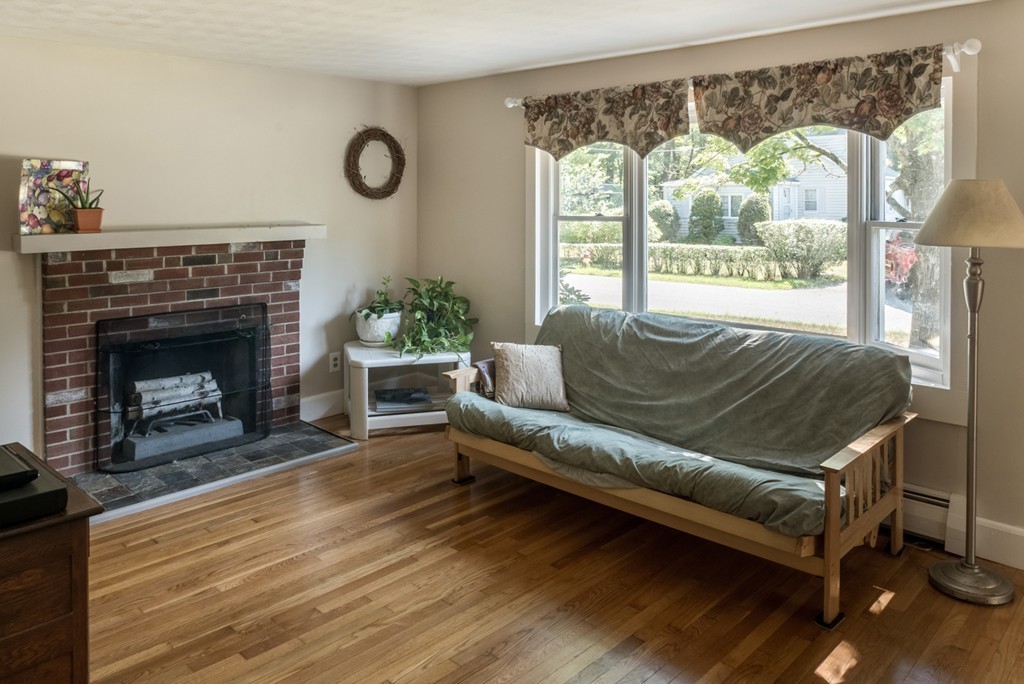 8 May Street Sharon, MA 02067 - Photo 6 of 8 a living room with furniture and a fireplace