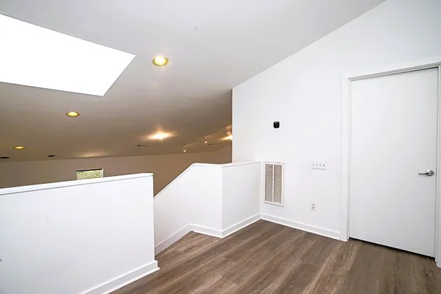 a view of a living room with wooden floor